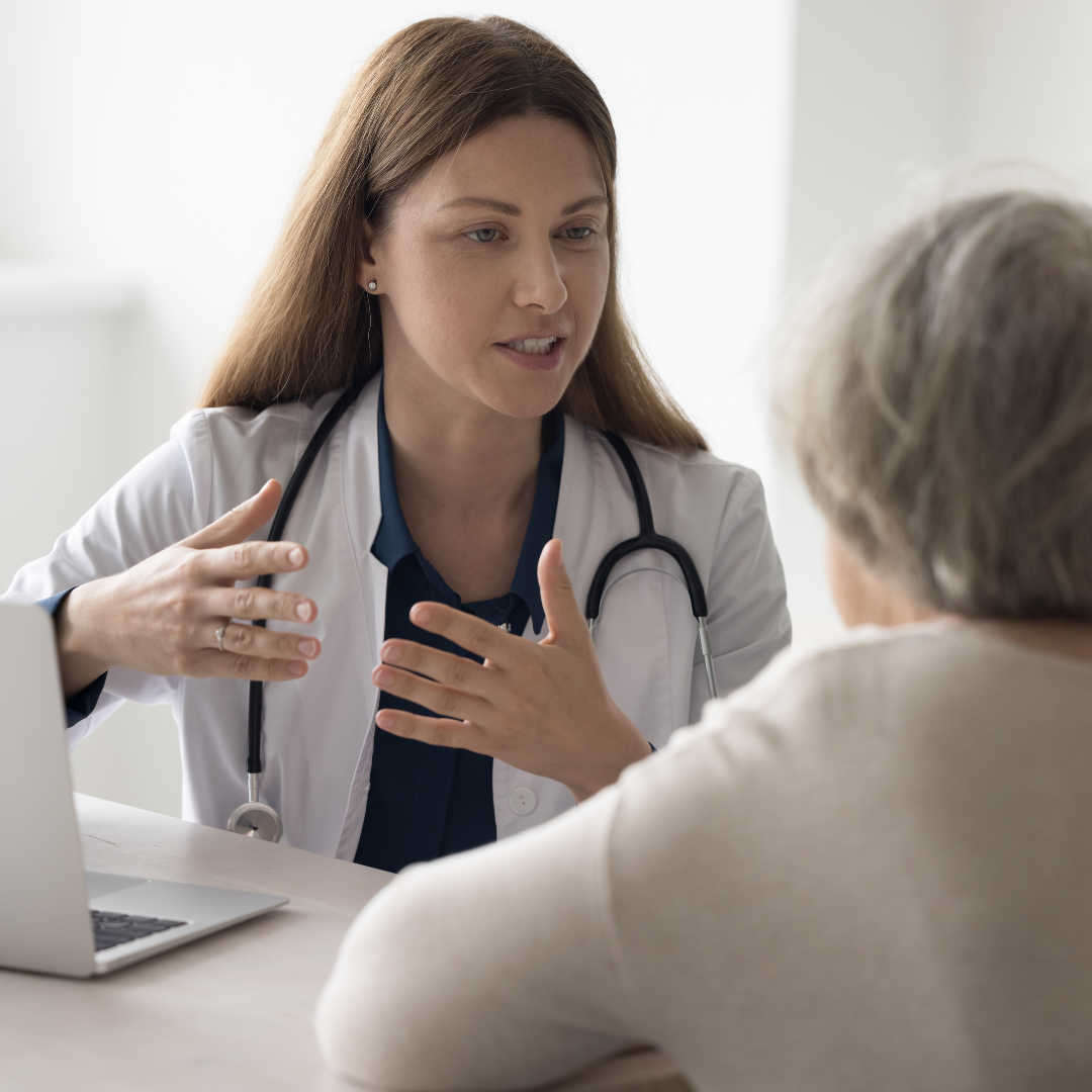 Female nurse discussing appointments with an elderly patient.