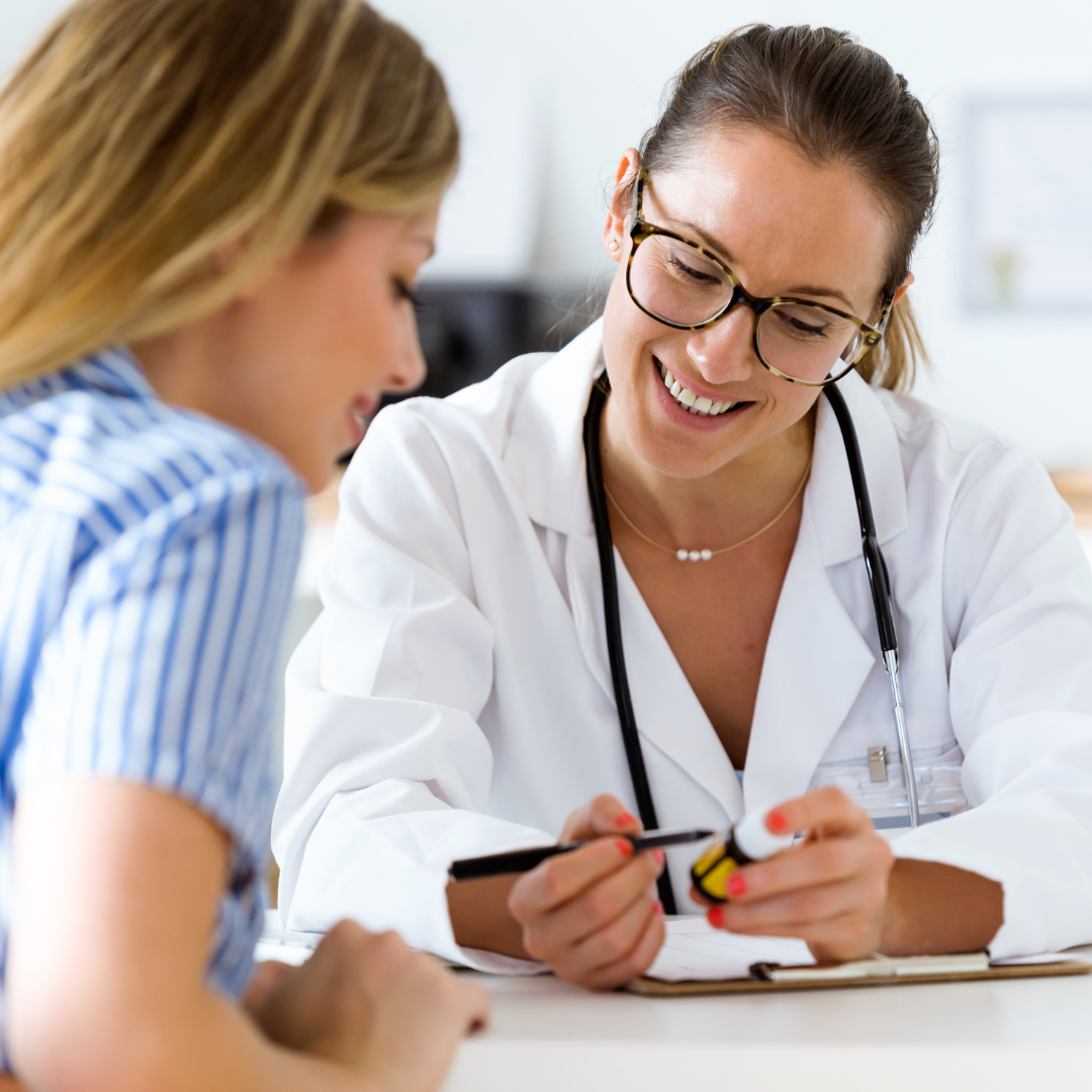 Female nurse scheduling a follow up for a female patient.