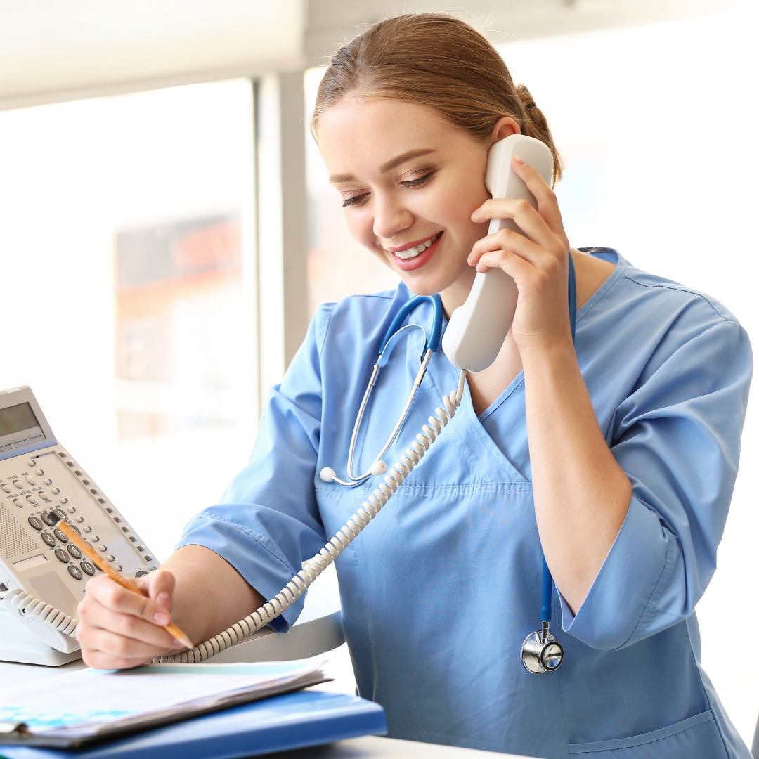 Nurse setting up a follow up appointment at a clinic.