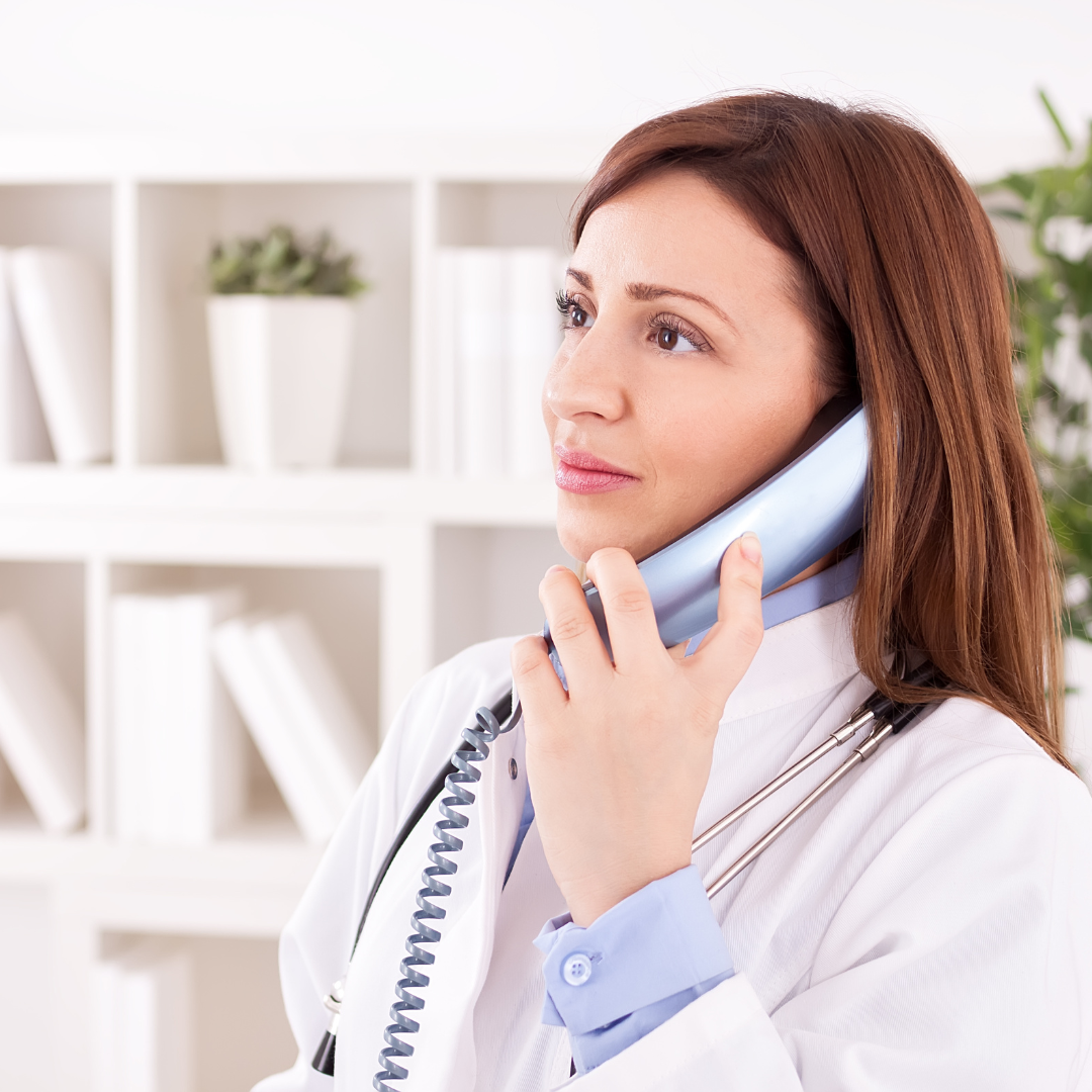 Nurse taking a call inside of a medical clinic.