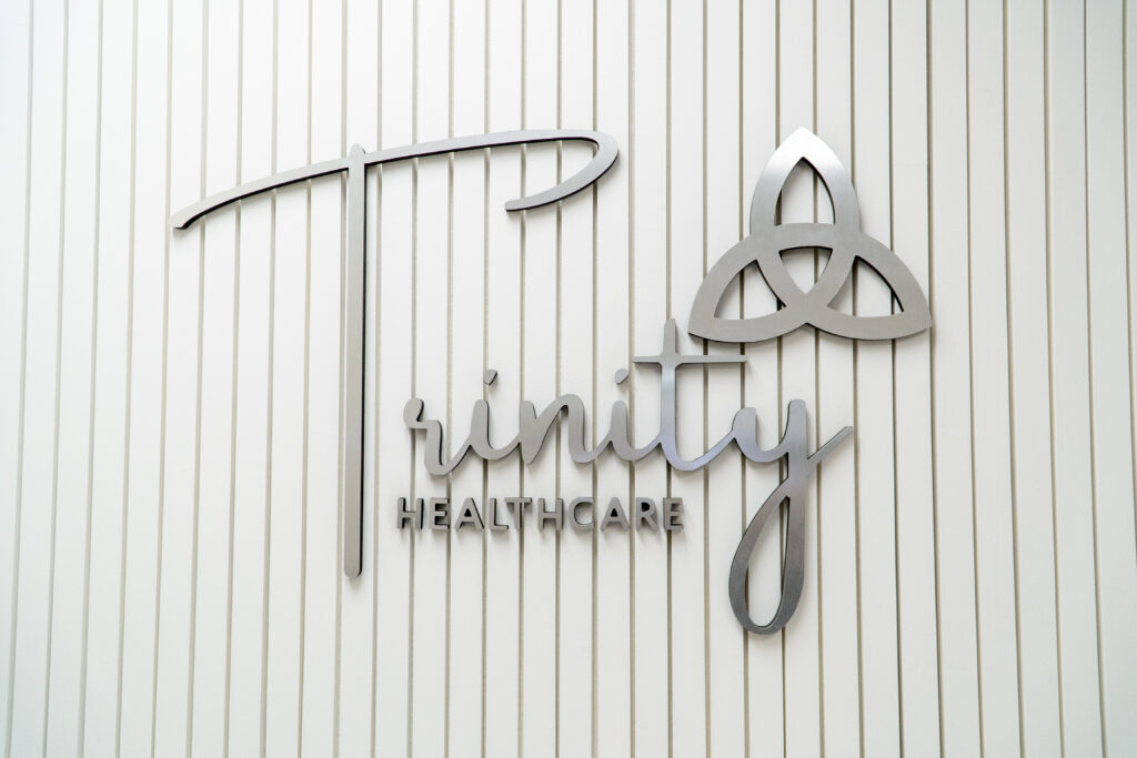 Trinity logo sign in the waiting room.